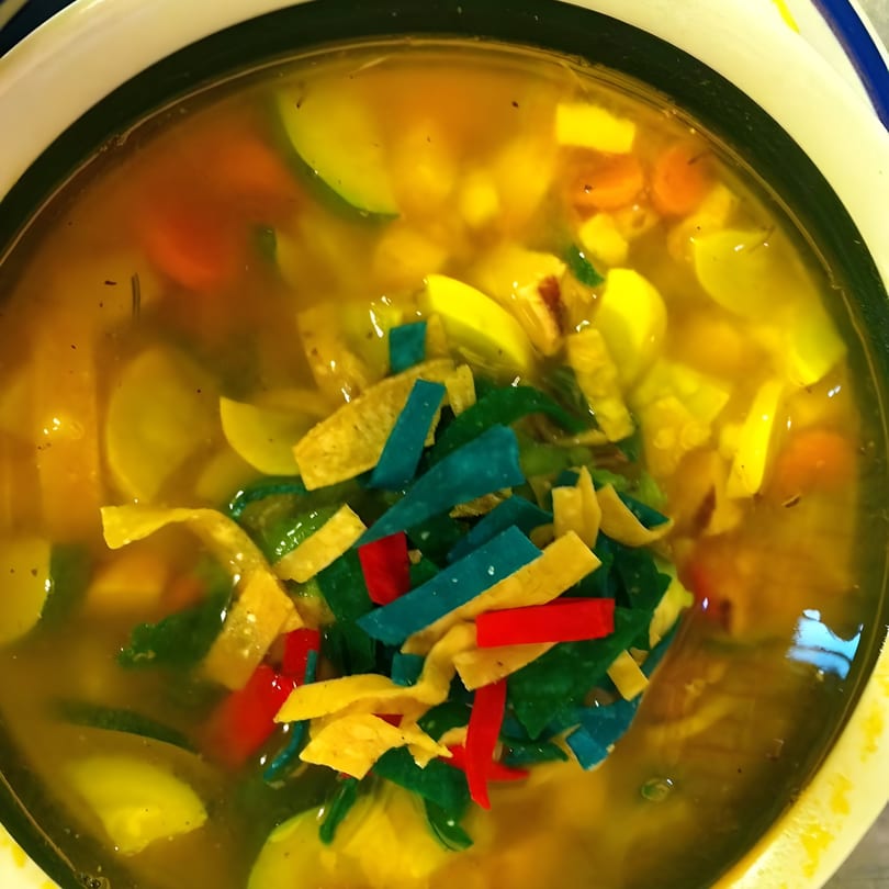 El Faro Mexican Foods' colorful tortilla soup with vegetables and vibrant tortilla strips.